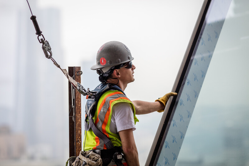 Construction worker taking a break on top of a building project